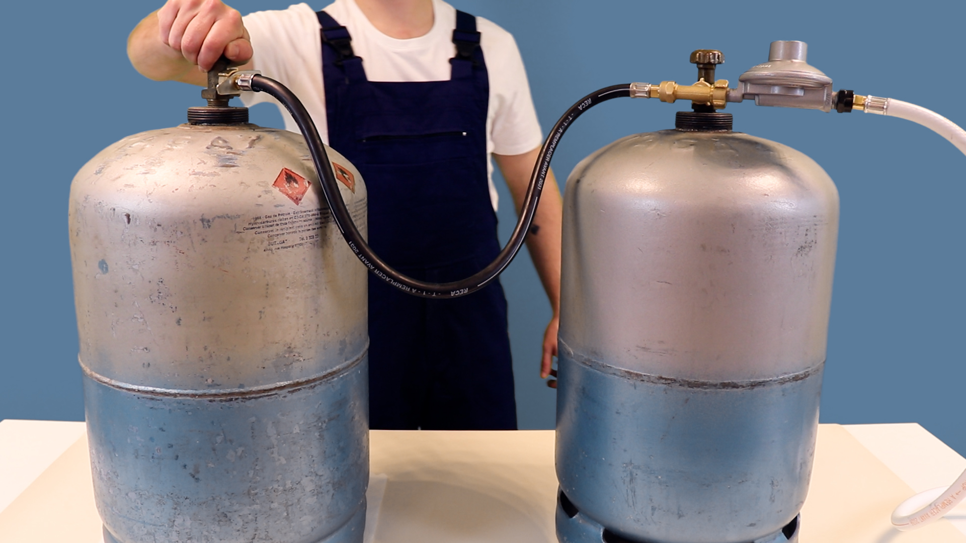 Raccord en té reliant deux bouteilles de gaz avec une lyre, détendeur et tuyau montés